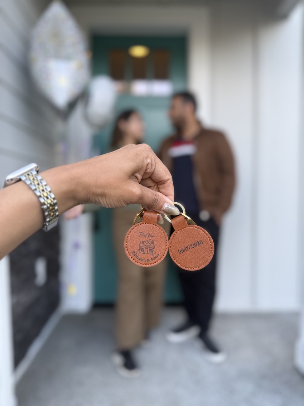 A couple receiving their first-home keychains on closing day